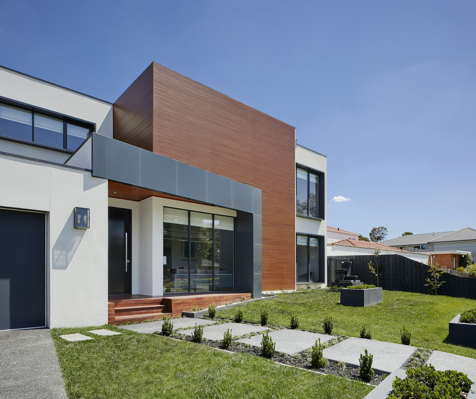 Covered threshold and stepping-stone walk at the indoor-to-outdoor edge of a house