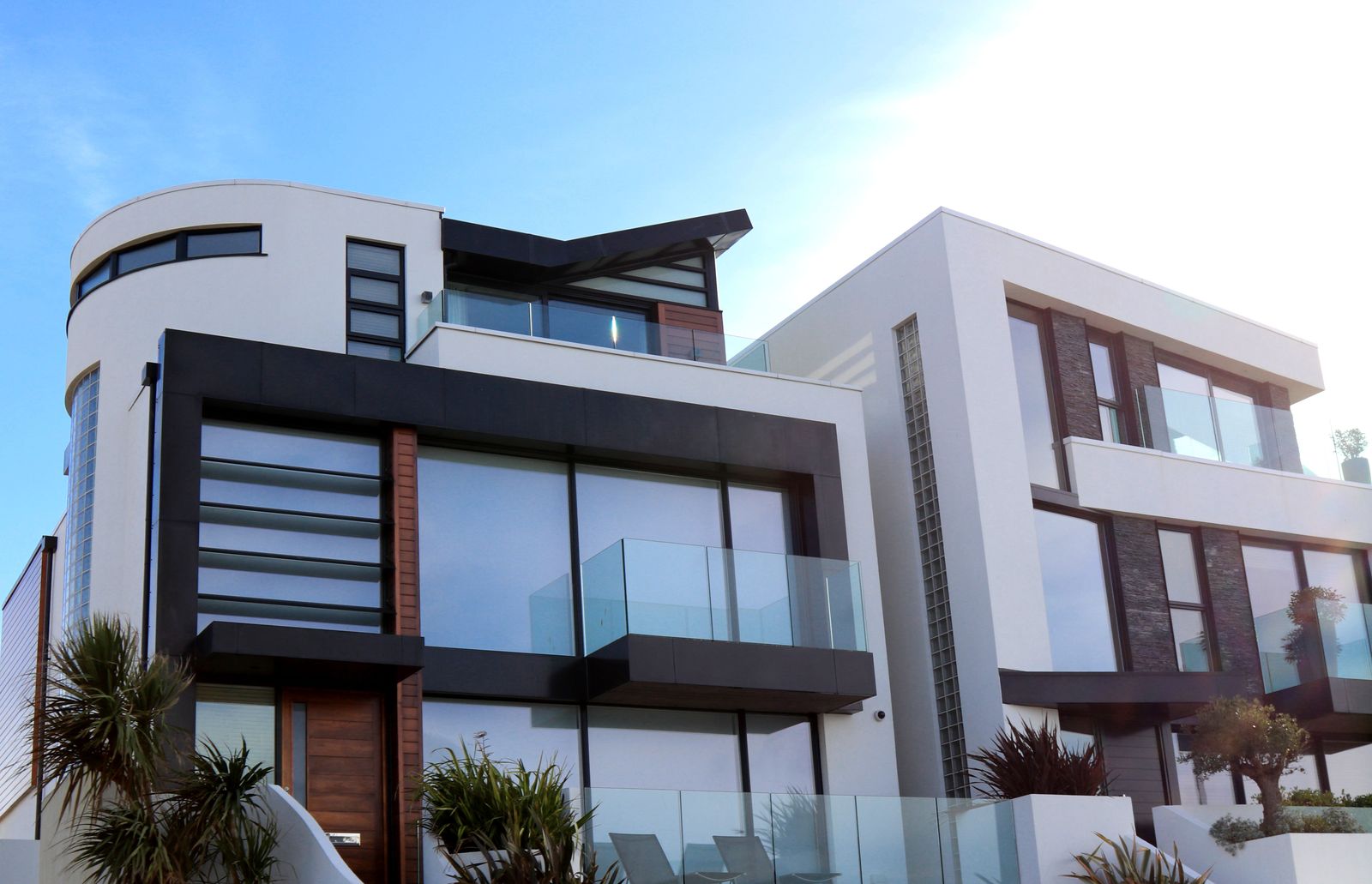 Contemporary house façade with recessed planes, glass, and a wood entry
