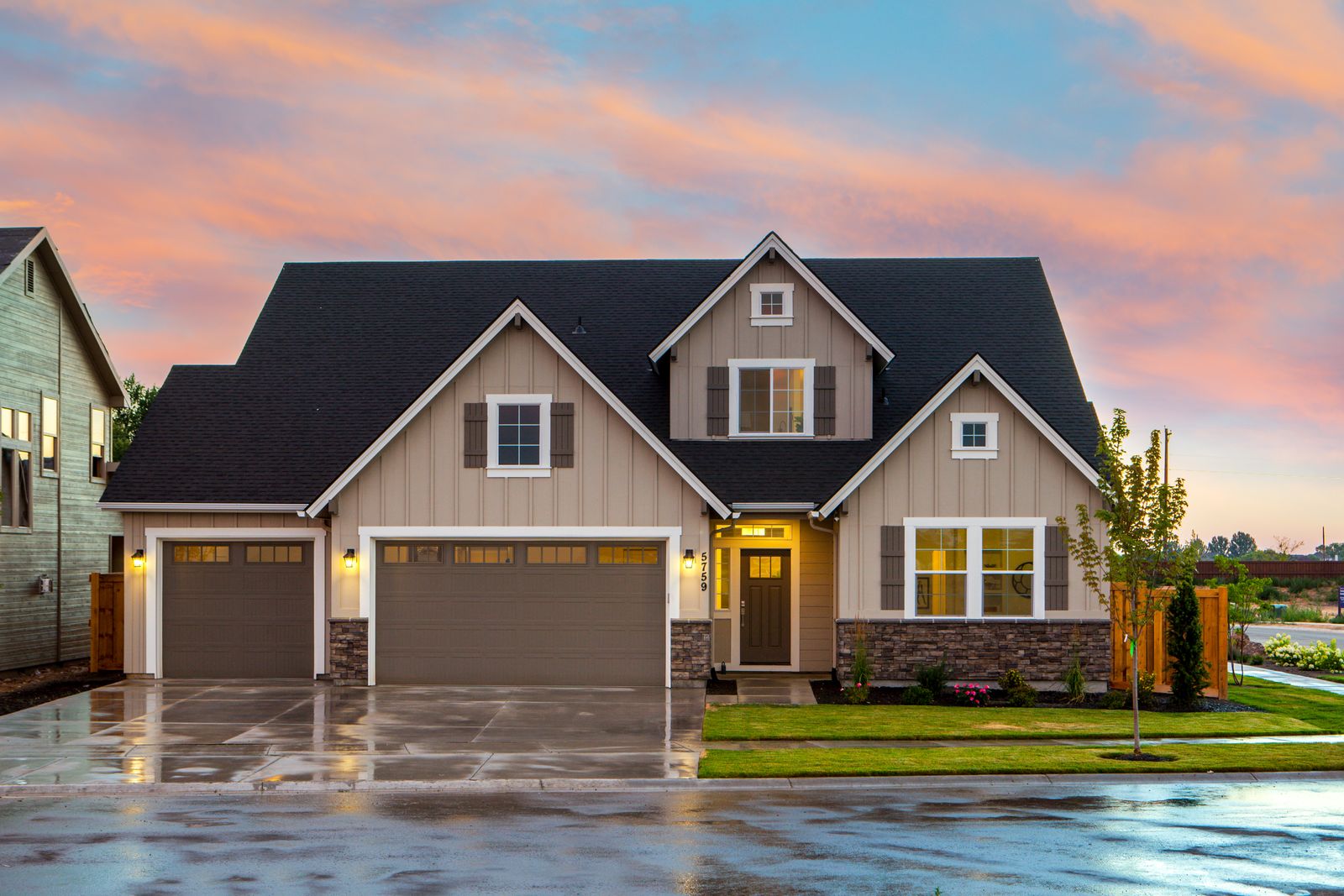 Suburban Sacramento-style residence at dusk with a warm porch light